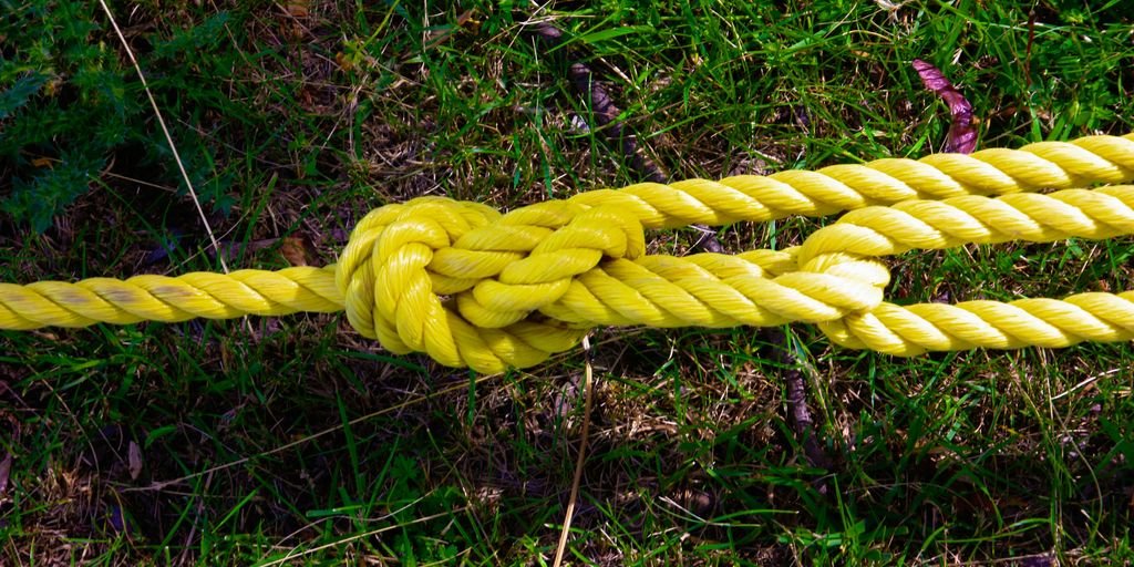 a close up of a yellow rope on the ground